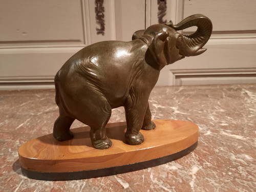 Regulated elephant on marble base.