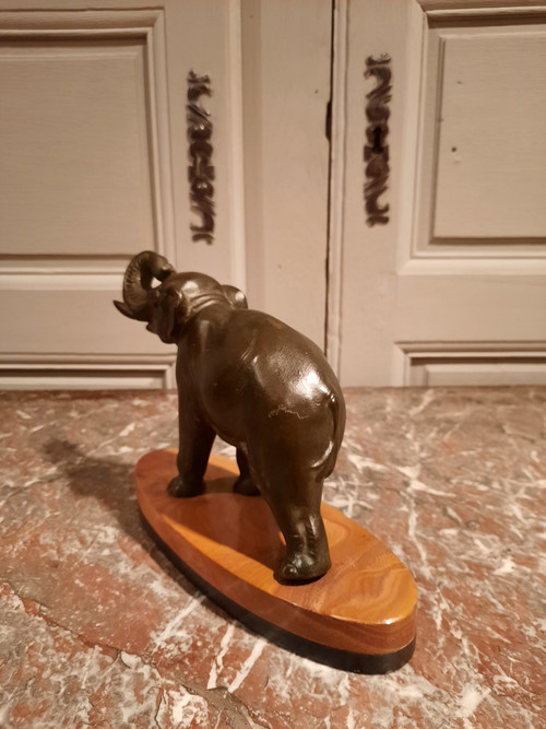 Regulated elephant on marble base.