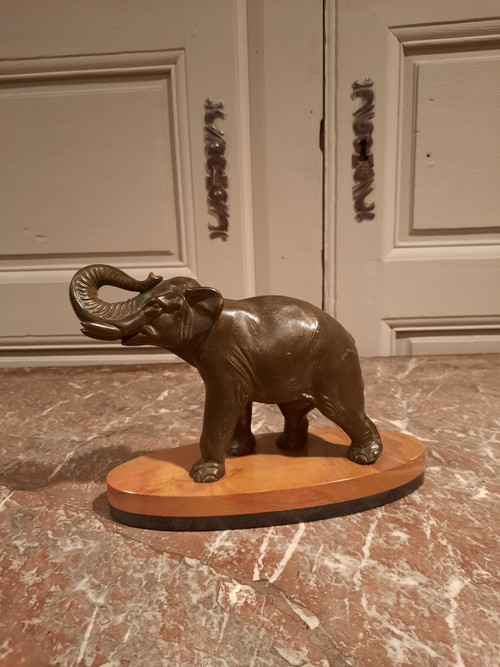 Regulated elephant on marble base.