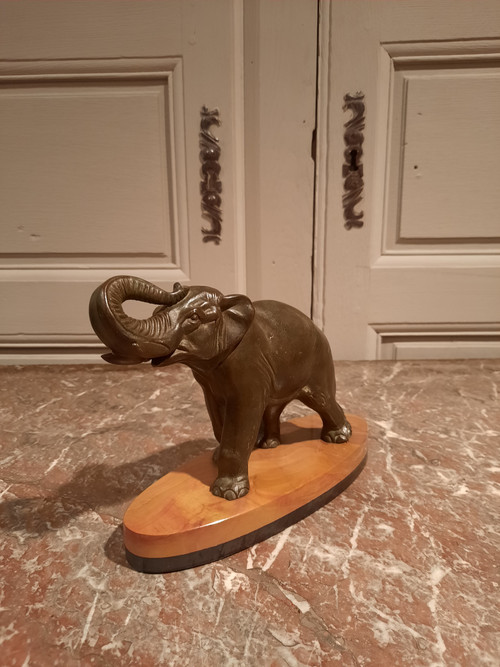 Regulated elephant on marble base.