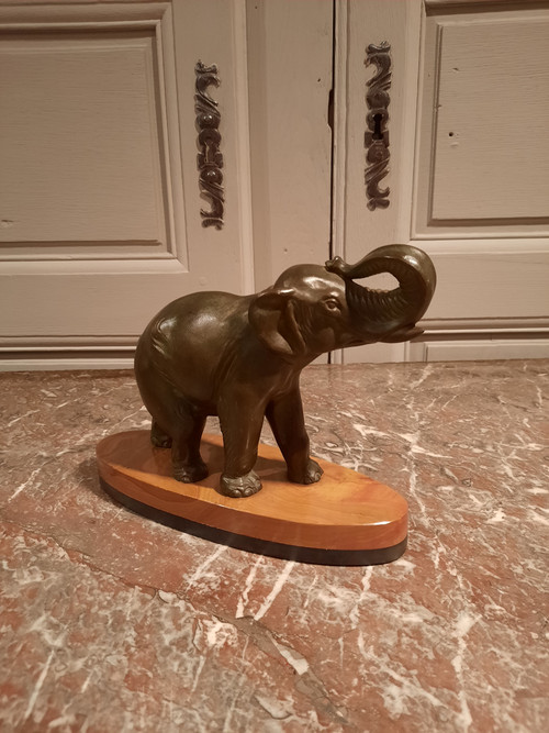 Regulated elephant on marble base.