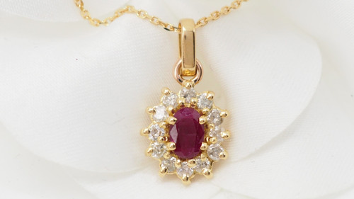 Collier pendentif marguerite en or jaune , rubis ovale et diamants 