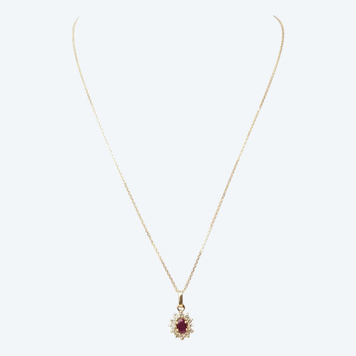 Collier pendentif marguerite en or jaune , rubis ovale et diamants 