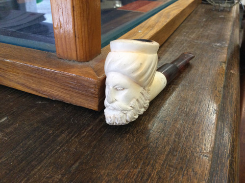 Carved head, pipe