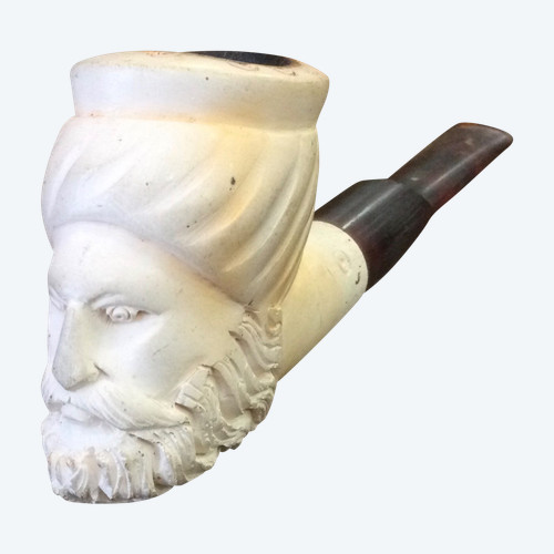 Carved head, pipe