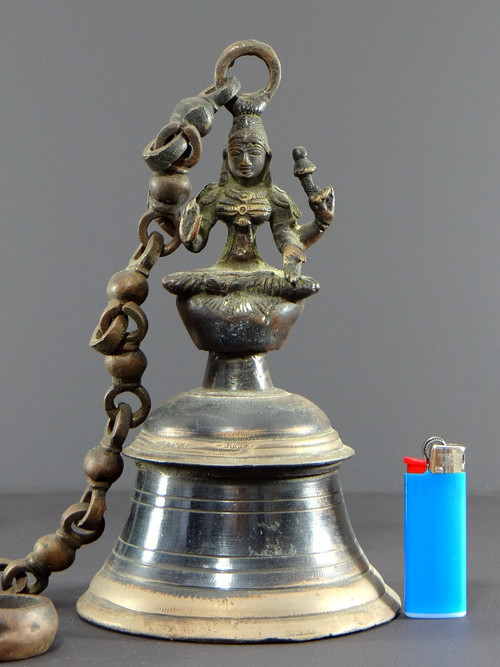 India, Mid-20th Century, Bronze bell adorned with a representation of the goddess Tripura.