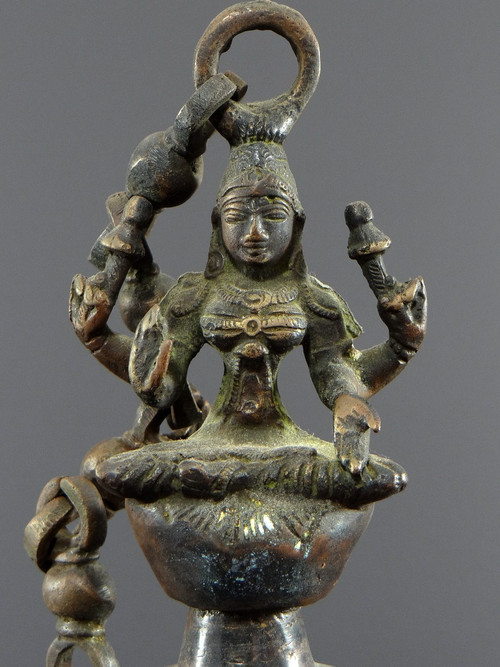 India, Mid-20th Century, Bronze bell adorned with a representation of the goddess Tripura.