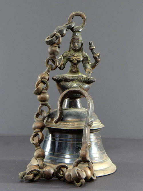 India, Mid-20th Century, Bronze bell adorned with a representation of the goddess Tripura.