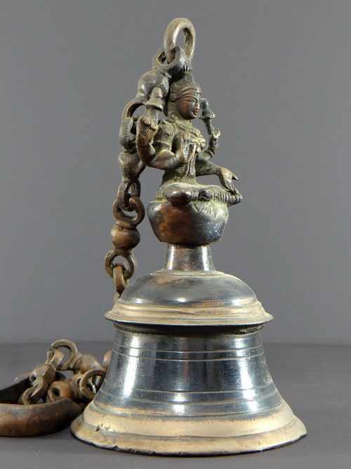 India, Mid-20th Century, Bronze bell adorned with a representation of the goddess Tripura.