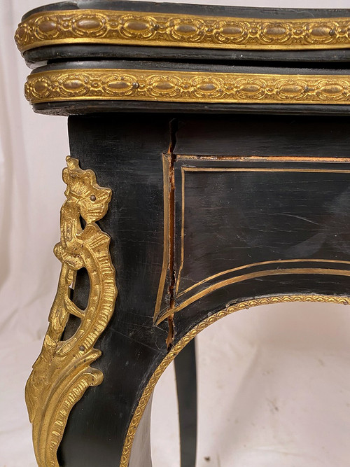 Napoleon III console forming a games table, blackened wood and brass marquetry