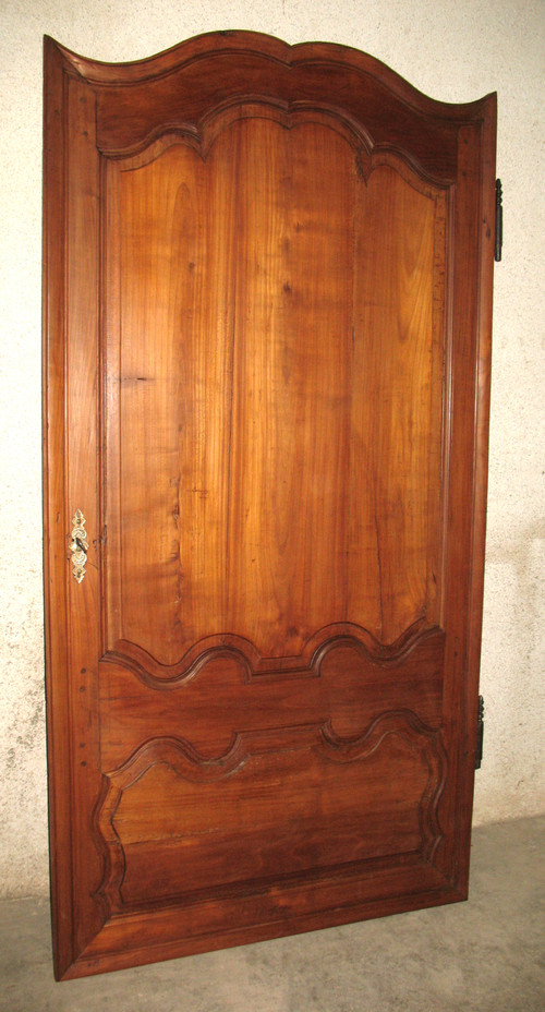 Louis XIV style molded woodwork door in cherry wood, late 18th century