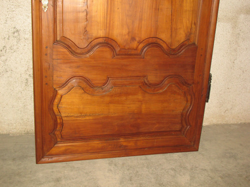 Louis XIV style molded woodwork door in cherry wood, late 18th century