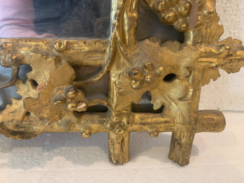 Louis XVI style mirror in carved wood and gilded with gold leaf, 19th century