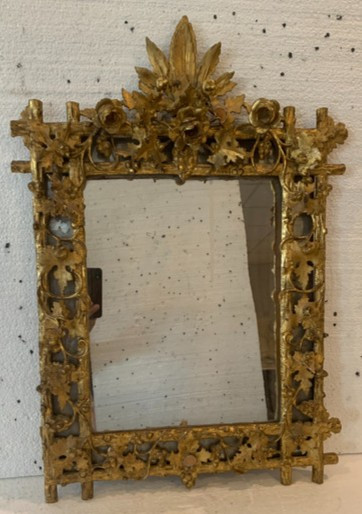 Louis XVI style mirror in carved wood and gilded with gold leaf, 19th century