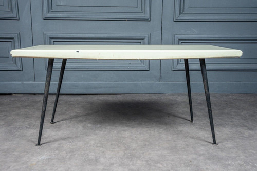 1960 coffee table with cream-colored top and designer tubular legs