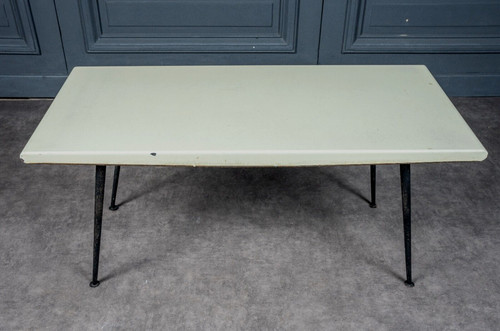 1960 coffee table with cream-colored top and designer tubular legs