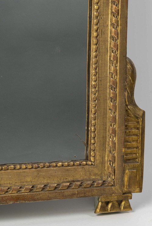 A large openwork pediment mirror in carved and gilded wood with musical attributes from the Louis XV