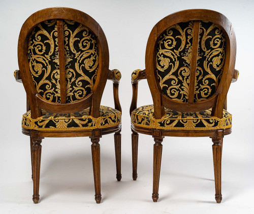 Pair of Louis XVI-style armchairs with medallion backs in carved and waxed molded natural wood