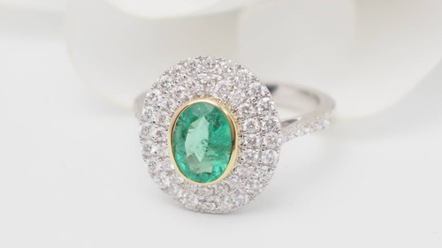 Surrounding ring in two-tone gold, oval emerald and diamonds