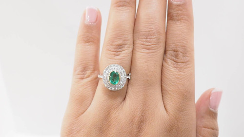 Surrounding ring in two-tone gold, oval emerald and diamonds