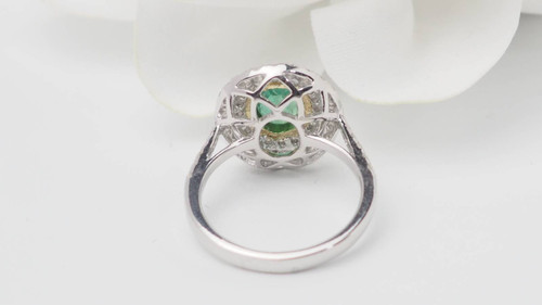 Surrounding ring in two-tone gold, oval emerald and diamonds