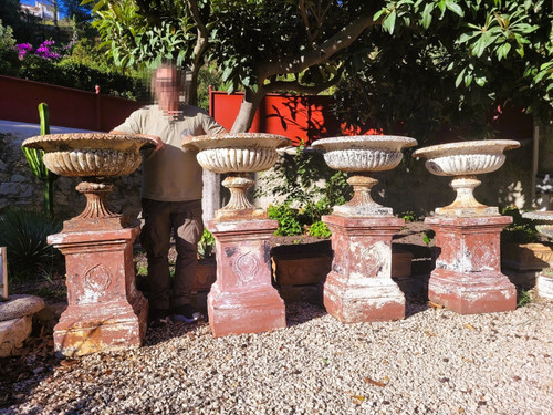 Set of 4 large cast iron garden vases on terracotta bases, 19th century