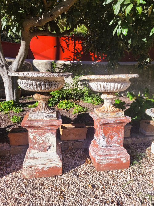 Set of 4 large cast iron garden vases on terracotta bases, 19th century