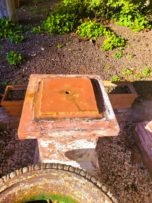 Set of 4 large cast iron garden vases on terracotta bases, 19th century