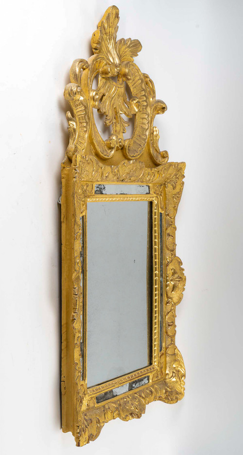 A French Regence period giltwood openwork pediment mirror circa 1720