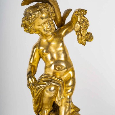 A pair of Napoleon III period gilt bronze Putti candlesticks, mounted as lamps