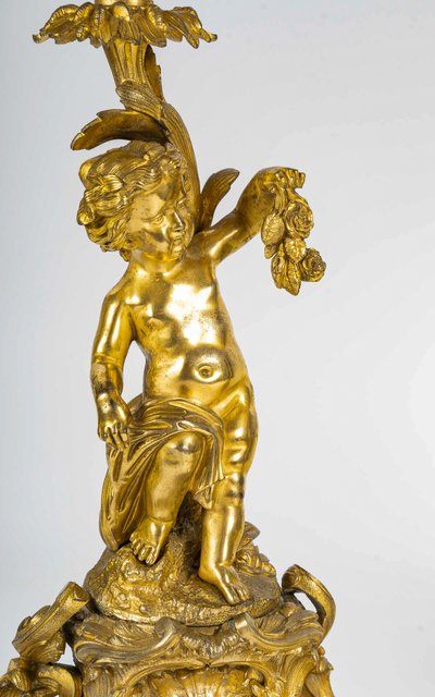 A pair of Napoleon III period gilt bronze Putti candlesticks, mounted as lamps