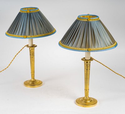 A pair of Restauration period chiseled gilt bronze candlesticks mounted as lamps circa 1820-1830