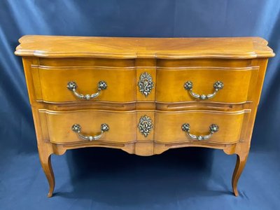 Large Louis XV-style bronze cherrywood commode with crossbow profile