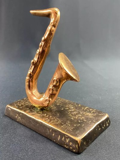 Carved saxophone subject in bronze signed Yves Lohé