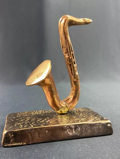 Carved saxophone subject in bronze signed Yves Lohé