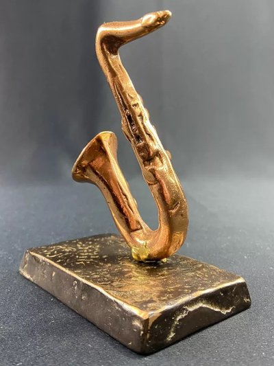 Carved saxophone subject in bronze signed Yves Lohé