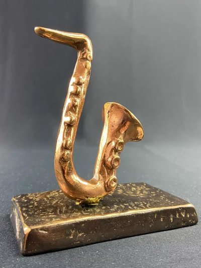 Carved saxophone subject in bronze signed Yves Lohé