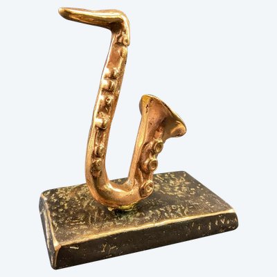 Carved saxophone subject in bronze signed Yves Lohé