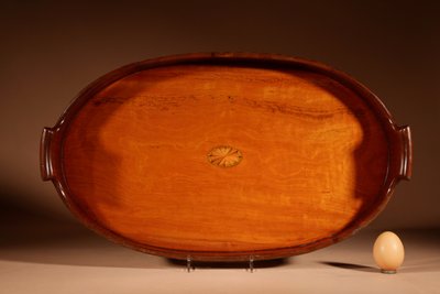 Unusual oval top in inlaid mahogany and satinwood.