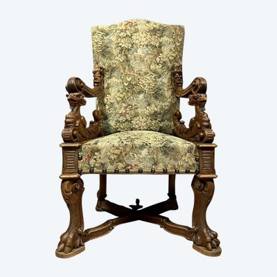 Renaissance throne armchair with slightly curved back in carved walnut.