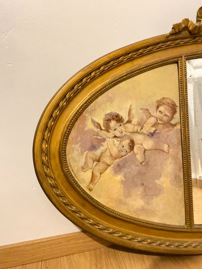 Gilded Oval Bevelled Mirror Surrounded By Two Paintings Of Cherubs 110cm X 70cm