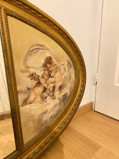 Gilded Oval Bevelled Mirror Surrounded By Two Paintings Of Cherubs 110cm X 70cm