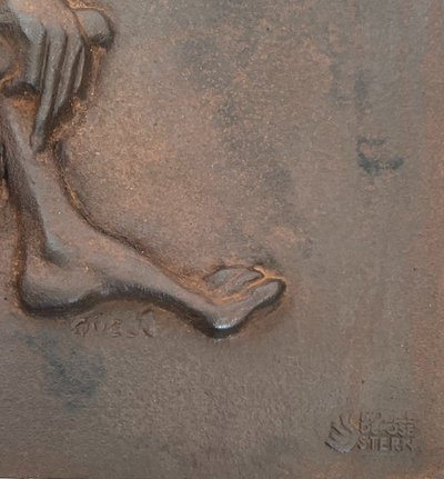 Modernist cast-iron plaque depicting a Nude Woman Holding a Scythe and Wheat Spikes.