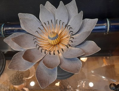 Painted metal water lily mounted on a wooden base