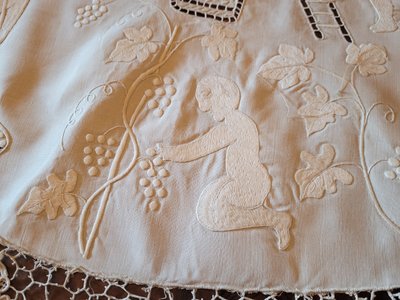 Embroidered pedestal tablecloth on the theme of grape harvests and wine, circa 1900