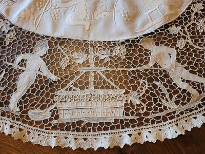 Embroidered pedestal tablecloth on the theme of grape harvests and wine, circa 1900