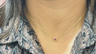 Yellow gold and ruby solitaire necklace