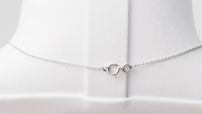 White gold and blue topaz solitaire necklace