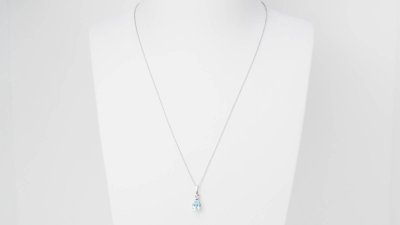 White gold and blue topaz solitaire necklace