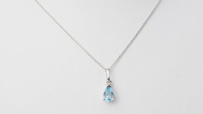 White gold and blue topaz solitaire necklace